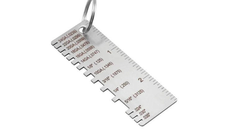 Metal thickness gauge keychain with labeled notches and inch ruler