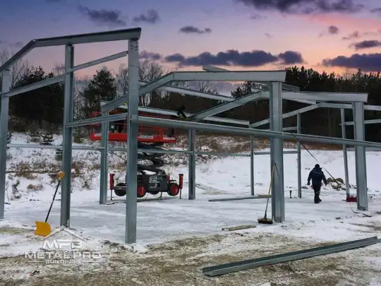 cfs building being erected on top of a prefab building foundation in the winter
