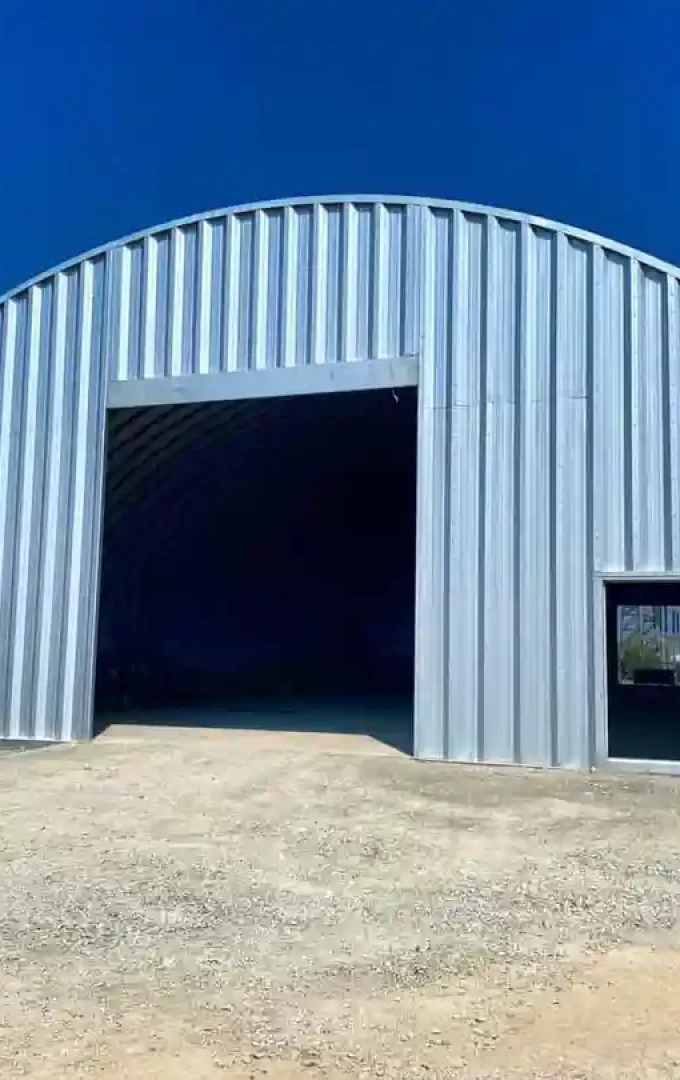 quonset equipment storage with garage and entry door opening