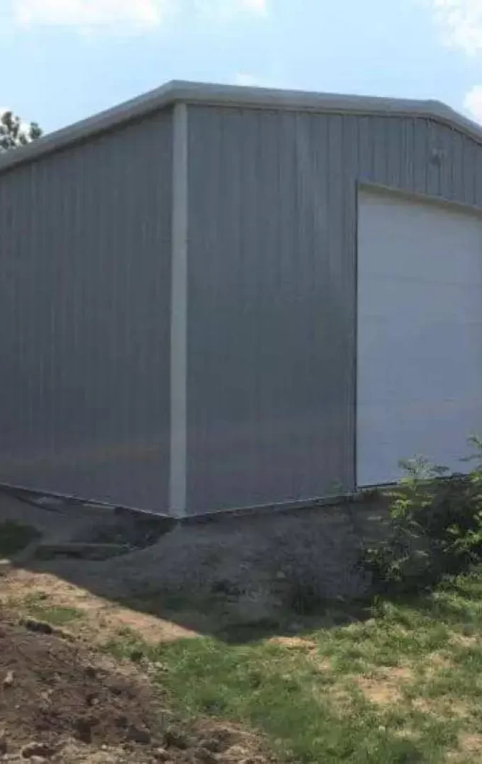 grey straight wall garage building with white garage doors
